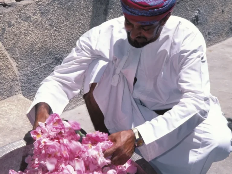 Omani-man-checking-rose-petals-Jebel-Akhdar-©-Ministry-of-Heritage-Tourism-Sultanate-of-Oman-scaled